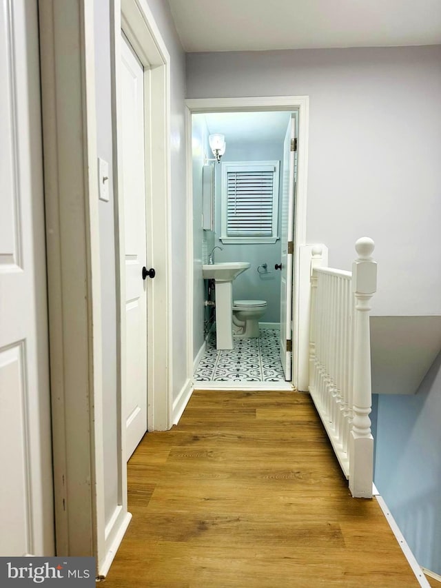 hallway featuring light hardwood / wood-style floors and sink