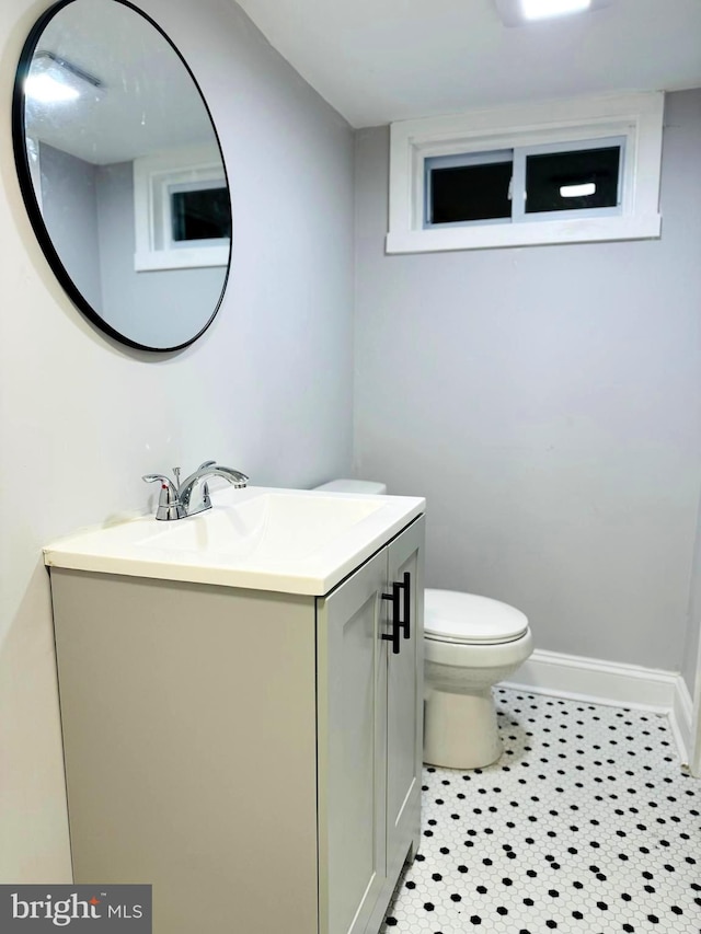 bathroom with tile patterned floors, vanity, and toilet