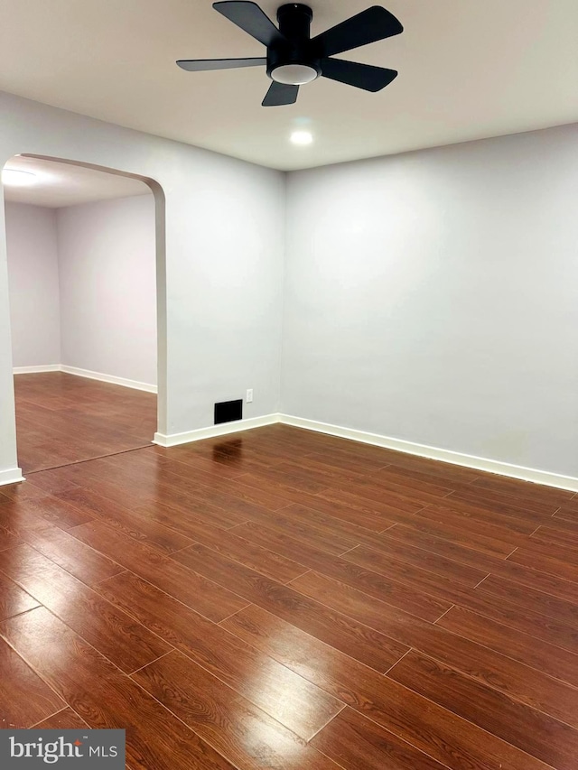 unfurnished room featuring ceiling fan and dark hardwood / wood-style floors