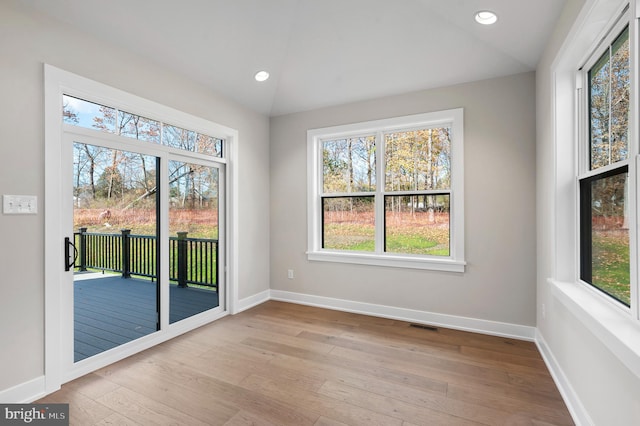 empty room featuring recessed lighting, light wood-type flooring, visible vents, and baseboards