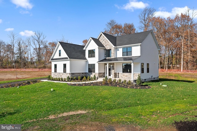 modern farmhouse style home with a porch, stone siding, a front lawn, and a standing seam roof