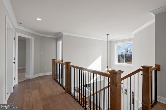 hallway featuring a chandelier, dark wood-style flooring, baseboards, and an upstairs landing