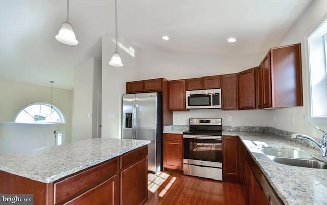 kitchen featuring pendant lighting, stainless steel appliances, dark wood-type flooring, and sink