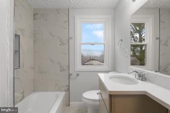 full bathroom featuring plenty of natural light, vanity, a textured ceiling, and toilet