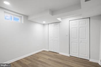 basement with hardwood / wood-style floors