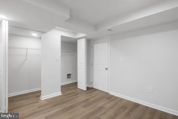 basement with hardwood / wood-style flooring