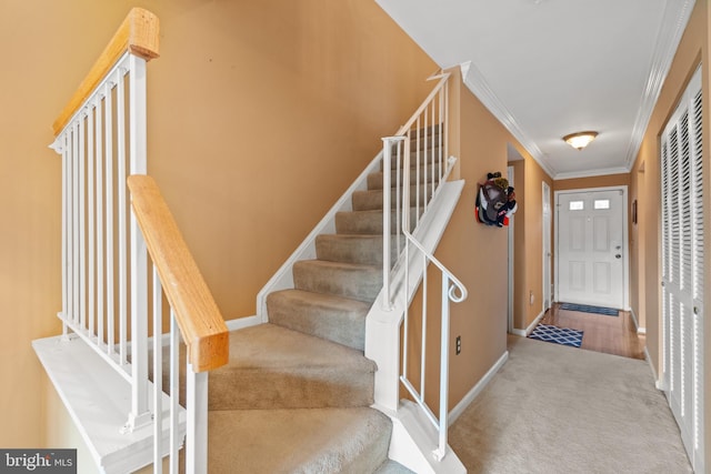 stairs with carpet flooring and ornamental molding