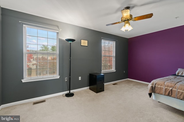 bedroom with ceiling fan and light carpet