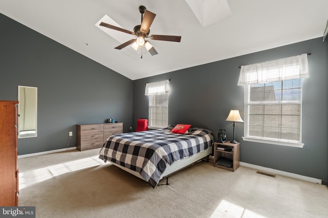 bedroom featuring ceiling fan, light colored carpet, and vaulted ceiling