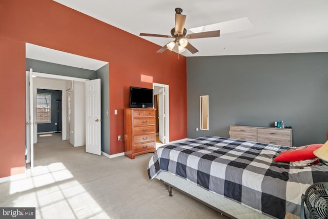 bedroom featuring ceiling fan, light colored carpet, and lofted ceiling