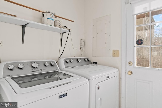 clothes washing area featuring independent washer and dryer, electric panel, and a wealth of natural light