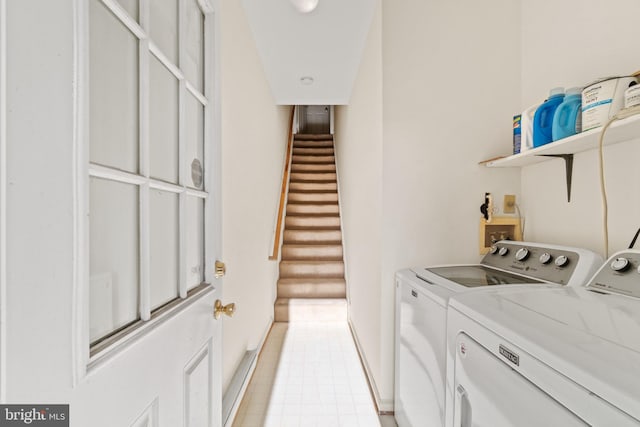 clothes washing area with washing machine and clothes dryer and light tile patterned floors