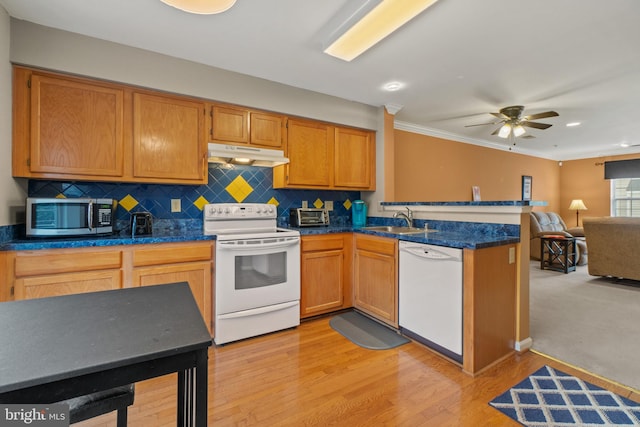 kitchen with ornamental molding, white appliances, ceiling fan, sink, and light hardwood / wood-style floors