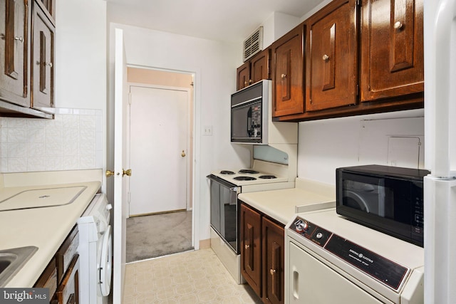 kitchen with sink, electric range, and backsplash