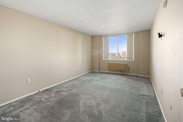 carpeted spare room featuring an AC wall unit