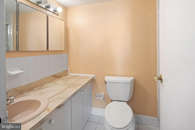 bathroom with tile patterned flooring, vanity, and toilet