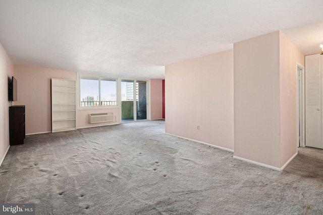 unfurnished living room featuring light carpet and a wall mounted AC