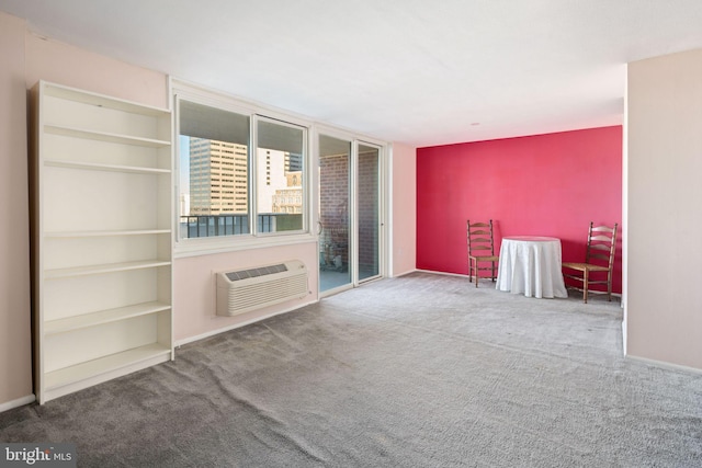 unfurnished living room with carpet floors and a wall mounted AC