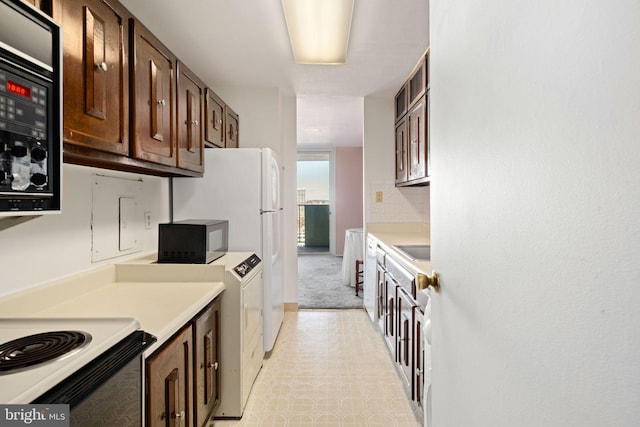 kitchen featuring sink, dark brown cabinetry, and black microwave