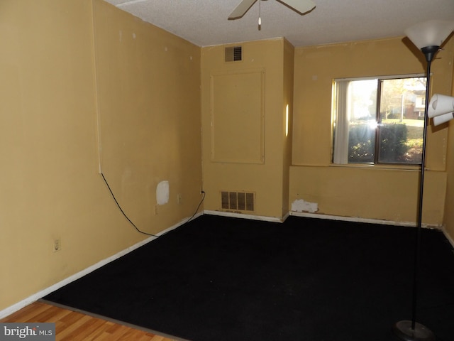 empty room with ceiling fan and wood-type flooring