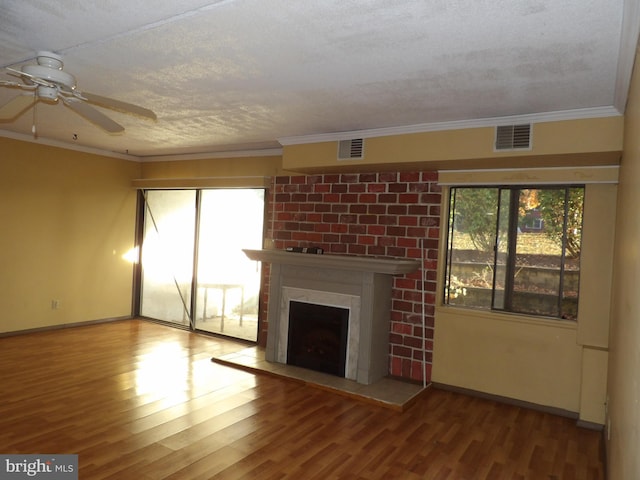 unfurnished living room with hardwood / wood-style floors, a healthy amount of sunlight, and a textured ceiling