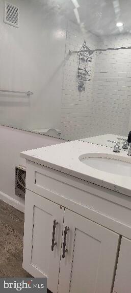 bathroom featuring vanity and a tile shower