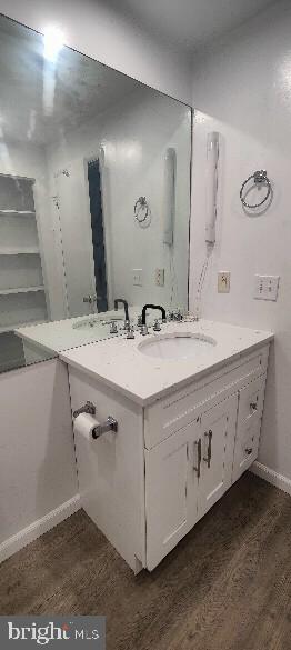 bathroom featuring wood-type flooring and sink