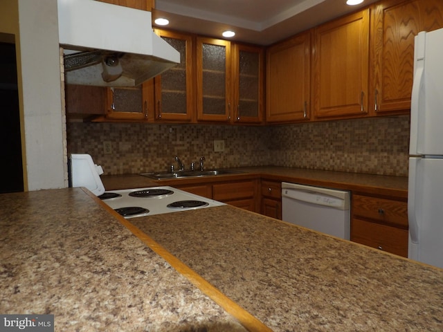 kitchen with decorative backsplash, white appliances, sink, and exhaust hood