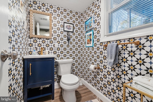 bathroom featuring hardwood / wood-style floors, vanity, tile walls, and toilet