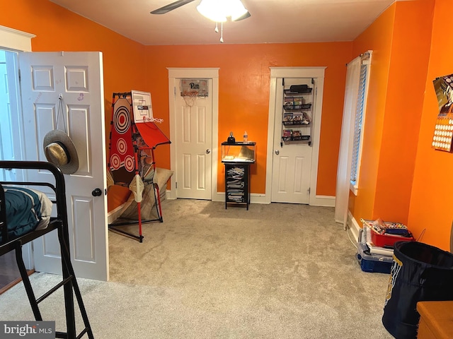 miscellaneous room featuring ceiling fan and light carpet