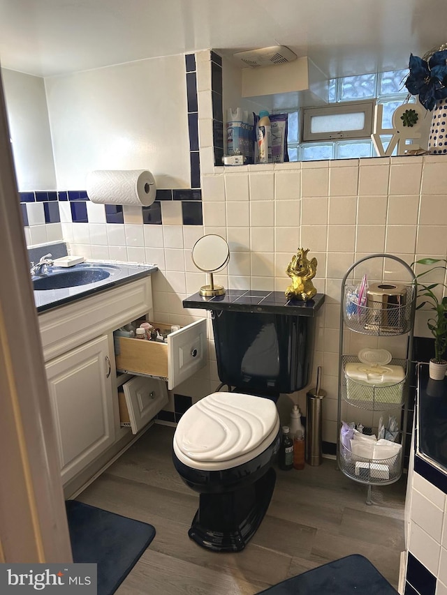 bathroom featuring wood-type flooring and tile walls