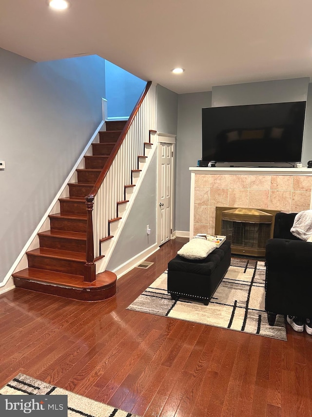 living room with a fireplace and hardwood / wood-style floors