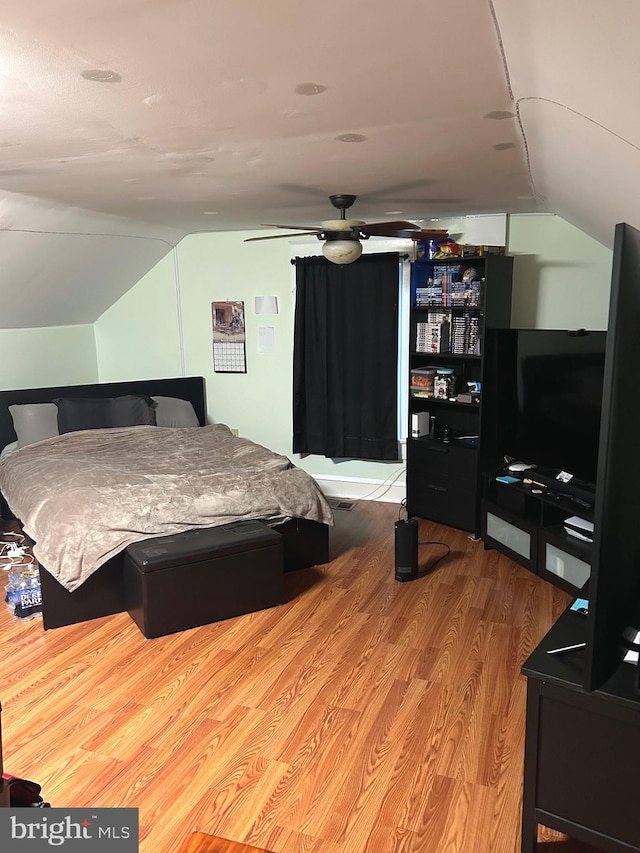 bedroom with lofted ceiling and light wood-type flooring