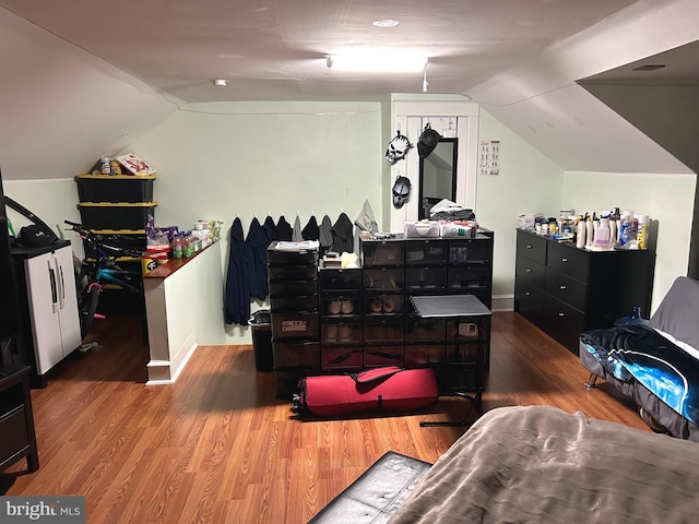 interior space featuring vaulted ceiling and hardwood / wood-style flooring