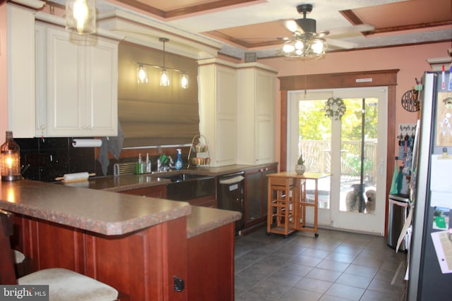 kitchen with pendant lighting, ceiling fan, ornamental molding, appliances with stainless steel finishes, and kitchen peninsula