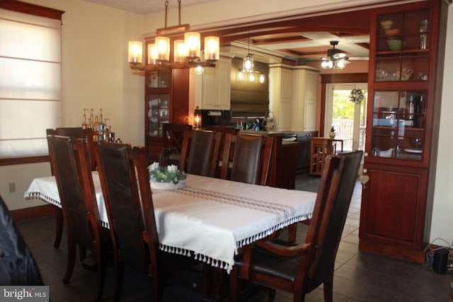 dining room featuring ceiling fan, beam ceiling, and dark tile patterned floors