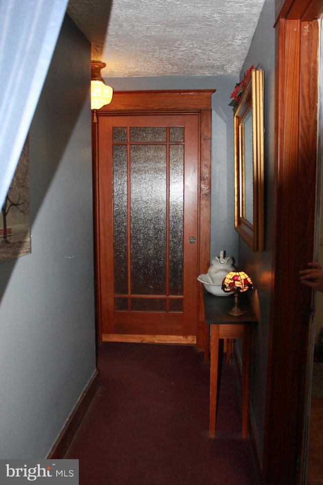 corridor with a textured ceiling