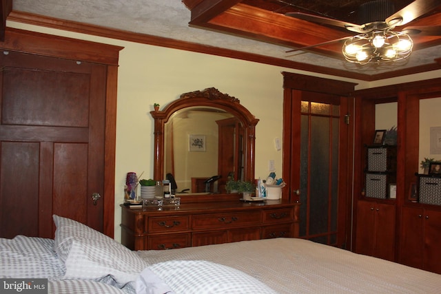 bedroom with ceiling fan and ornamental molding