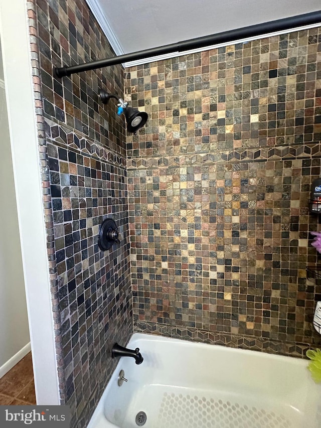 bathroom featuring tile patterned floors, tiled shower / bath combo, and ornamental molding