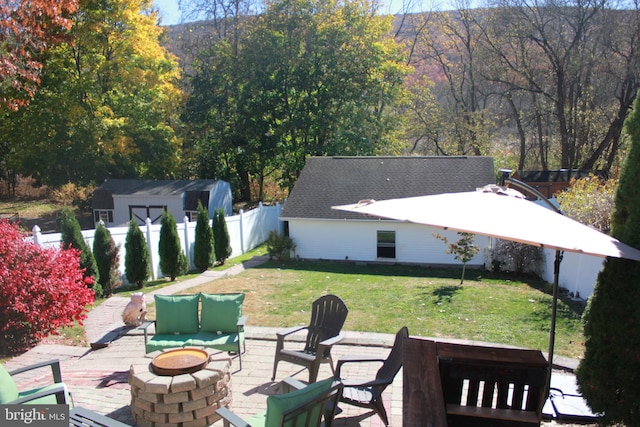 view of patio with a shed and a fire pit