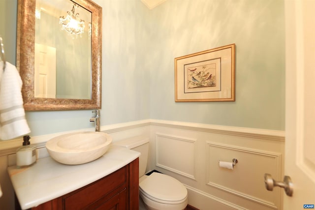 1790 Shelbourn Ln, Keswick, VA 22947 - half bathroom featuring a decorative wall, toilet, vanity, and a wainscoted wall