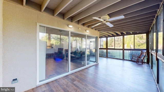 unfurnished sunroom featuring ceiling fan