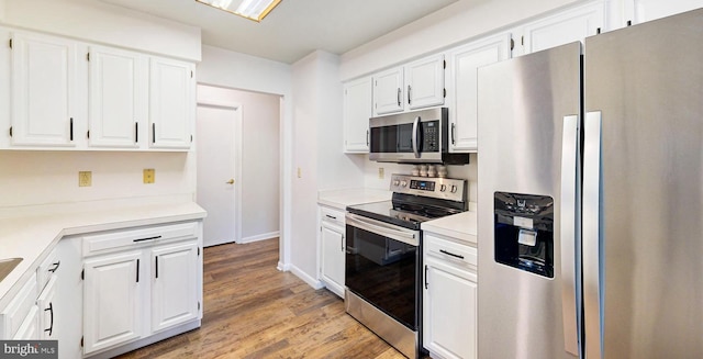 33945 Middleton Cir Unit 1, Lewes, DE 19958 - kitchen featuring appliances with stainless steel finishes, white cabinets, and light wood-type flooring