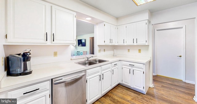 33945 Middleton Cir Unit 1, Lewes, DE 19958 - kitchen featuring dishwasher, a sink, white cabinets, and light wood finished floors