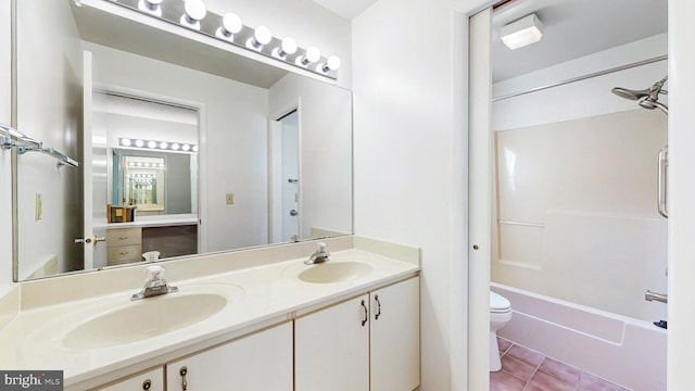 full bathroom featuring toilet, bathtub / shower combination, vanity, and tile patterned floors