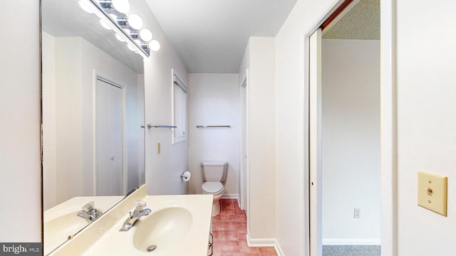 bathroom featuring tile patterned floors, vanity, and toilet