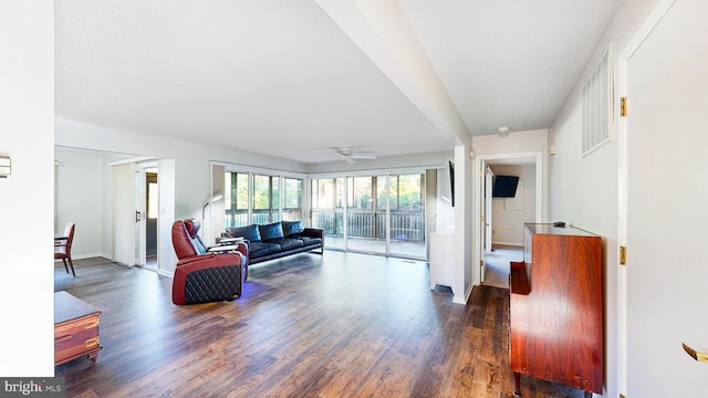 living room with ceiling fan and dark hardwood / wood-style flooring