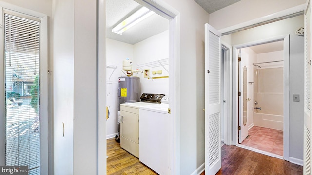 laundry area featuring washer and dryer and dark wood-type flooring