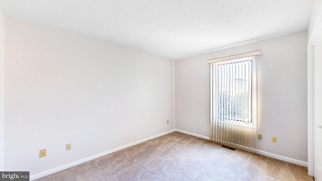 33945 Middleton Cir Unit 1, Lewes, DE 19958 - spare room with carpet, a textured ceiling, and baseboards