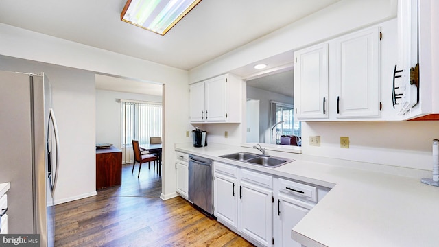 kitchen featuring wood-type flooring, white cabinetry, sink, and appliances with stainless steel finishes